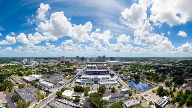 Aerial view of downtown Orlando with the Orlando City Soccer (Lions) stadium in the foreground.   The word "Orlando" is spelled out and visible in this image within the soccer stadium. May 2, 2022.