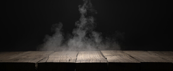Wooden plank podium or table in the dark with smoke over it