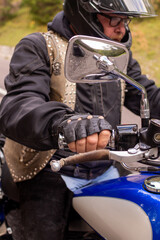 Guy riding retro cruiser motorcycle  on mountain road in South tyrol