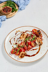 Tradition italian salad panzanella with croutons, onion and tomatoes. Tomatoes salad with bread on ceramic plate in contemporary style. Italian food. Aesthetic composition with panzanella salad.