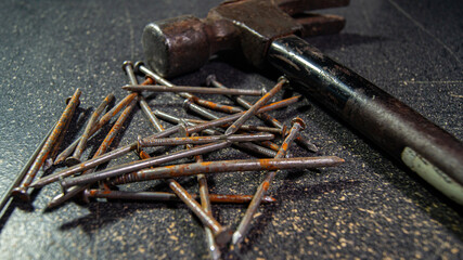 old hammer with old and rusty nails