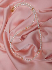 Beautiful necklace on a pink background. Luxury female jewelry