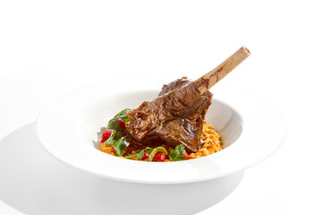 Slow roast leg of lamb with pumpkin stew and grilled tomatoes. Lamb leg with vegetables isolated on white background. Main course on fine dining. Gourmet dish from meat on bone. Meat menu.