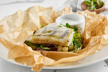 White fish fillet with broccoli in rustic style. Healthy eating: cooked fish fillet with vegetables...
