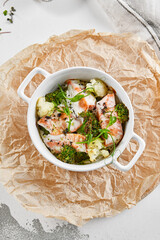 Healthy eating: steamed vegetables with salmon. Healthy salmon meal with broccoli and cauliflower. Casserole with fish and broccoli for lunch. Broccoli dish in diet menu. Cooked fish and veggies.