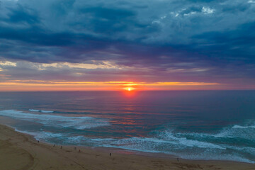 Fototapeta premium Sunrise reflections and clouds at the seaside with lagoon