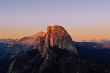 The peak of half dome illuminated in evening sunset light against a blurred backdrop in Yosemite National Park, California, USA.  © Danique
