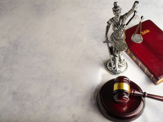 Symbols of American justice - a figurine of the goddess of justice - Themis, a judge's gavel and a...