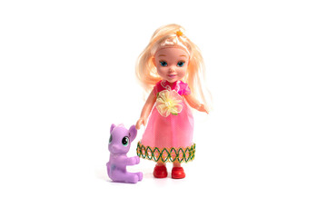 Plastic doll toy with unicorn isolated on white.