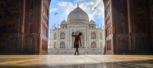 a boy standing near taj mahal, Standing near River Yamuna. Taj Mahal is famous for Own beauty and one of the wonders of the world.