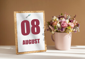august 8. 8th day of month, calendar date.Bouquet of dead wood in pink mug on desktop.Cork board with calendar sheet on white-beige background. Concept of day of year, time planner, summer month