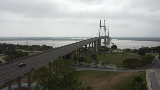 aerial scenic flight with a view of the roundabout and bridge of the parana river in rosario argentina