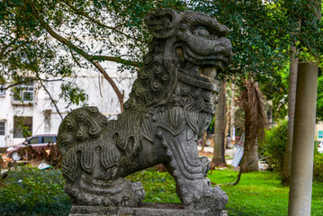Close-up of an old stone lion in a traditional Chinese garden