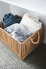winter lifestyle and cosy home decor, soft fluffy blankets and throws in rattan basket