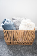 winter lifestyle and cosy home decor, soft fluffy blankets and throws in rattan basket
