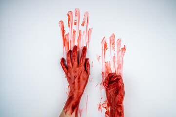 Female hands in blood on a white background. 