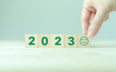 Happy new year 2023.  Starting to new year. 2023 written on wooden cubes with smart background. .Happy people for better of living. Green community. Goals, plan, opportunity and new business or life.