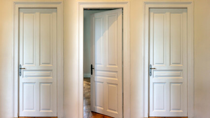 Open and closed door on house wall. Three interior retro wooden doorway, white classy, front view.