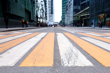 Empty crosswalk in a city, defocused view to business center. People on a street on and skyscrapers in Moscow city