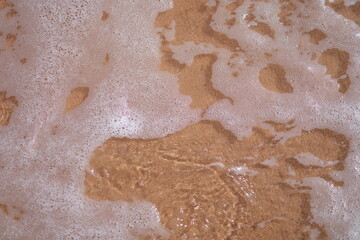 Soft ocean or sea wave with foam on sandy beach