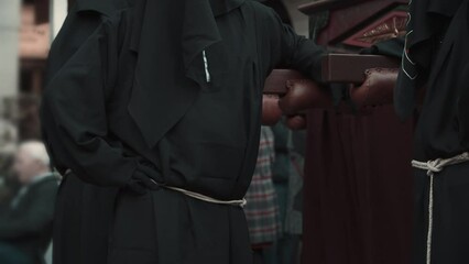 Robed worshippers get ready for the procession during Holy Week in the streets of Spain.