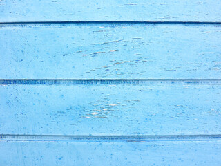 Fototapeta na wymiar Bright blue painted wooden planks close up, detail of an old Mediterranean house door. Space for your text or logo.