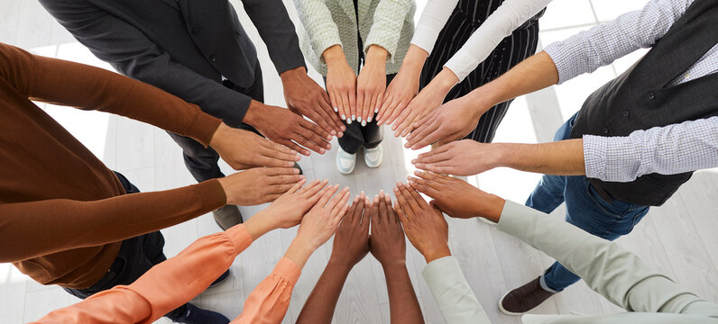 Narrow banner of diverse multiracial people join hands in circle engaged in teambuilding activity at workplace. Motivated international team have teamwork training. Diversity concept.