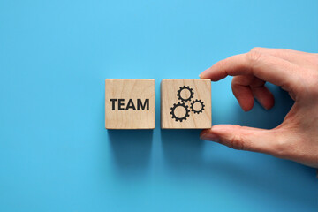 The inscription: the team and the gears are next to each other. A symbol of the well-coordinated...