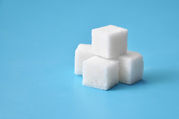 Pyramid of sugar on a blue background