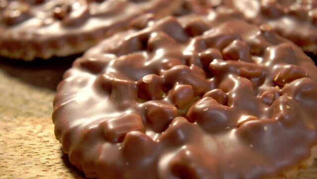 Cookies with nut dipped in milk chocolate. With pine nuts and peanuts. Macro. Dolly shot.
