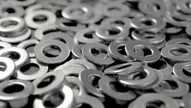 Shiny round metallic washers. Metal steel chrome hardware. Engineering tool. Macro. Rotation
