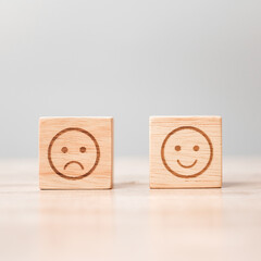 emotion face symbol on wooden blocks. Service rating, ranking, customer review, satisfaction,...