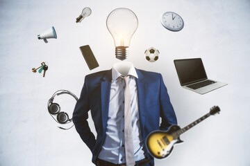 Abstract image of headless businessman with idea head, laptop, guitar and other items flying around...