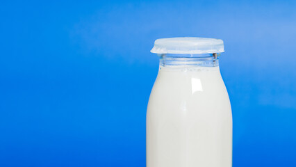 A bottle of milk isolated on blue background, Drink or beverage image, Breakfast