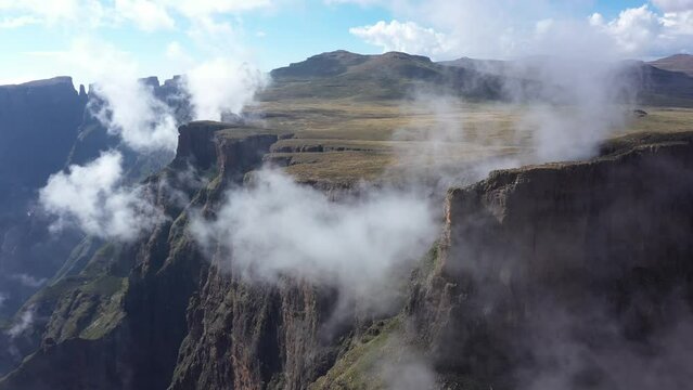Flying among clouds at Drakensberg highlands at Royal natal national park, South Africa