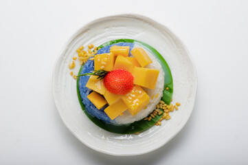 Ripe Mango with Coconut Flavored Sticky Rice on white dish, .Popular Thai desserts,Food and Desserts concept.