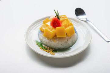 Ripe Mango with Coconut Flavored Sticky Rice on white dish, .Popular Thai desserts,Food and Desserts concept.