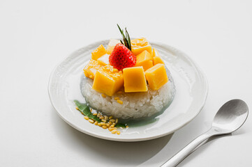 Ripe Mango with Coconut Flavored Sticky Rice on white dish, .Popular Thai desserts,Food and Desserts concept.