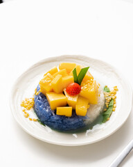 Ripe Mango with Coconut Flavored Sticky Rice on white dish, .Popular Thai desserts,Food and Desserts concept.