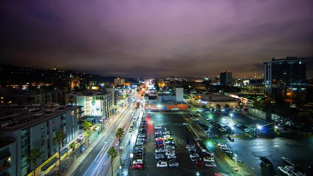 Aerial Lockdown Time Lapse Shot Of Clouds Moving Over Illuminated City At Night - Hollywood, California