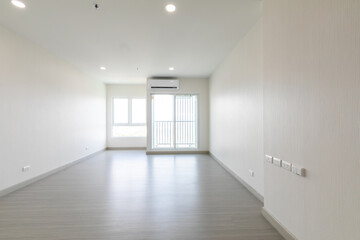 Bright empty interior with two large window, city view and blank gray wall.