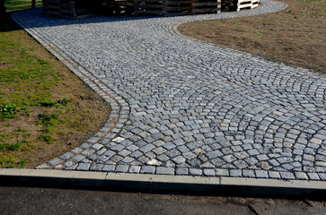 wooden prisms stacked in a circle dry better. cobblestones on the road view from the drone to the...