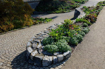 beautifully folded retaining wall with a granite attic with small joints. brown beige yellow...