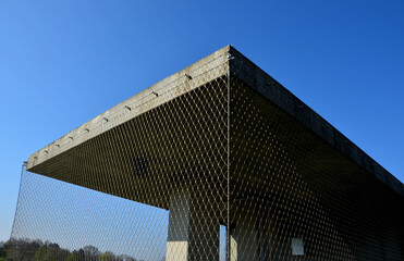 square concrete shelter netted with stainless steel. net of ropes braided together with buckles....
