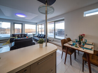 Modern interior of spacious studio apartment. Black leather furniture