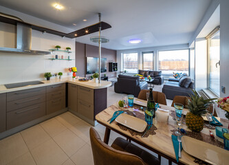 Modern interior of spacious studio apartment. Black leather furniture