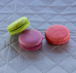 Three macarons arranged in a composition..Multicolored cookies.