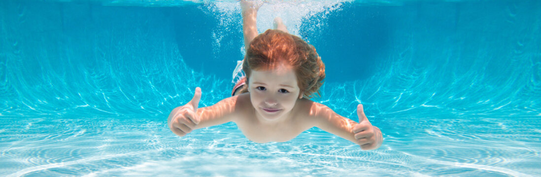 Child swimming underwater with thumbs up. Underwater kid swim under water. Child boy swimming and diving underwater in pool. Banner for header, copy space. Poster for web design.