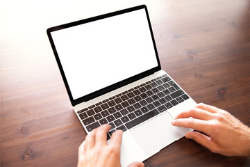 Person using laptop computer, blank white screen mockup