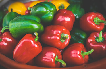 Group of red , green and yellow bell peppers.